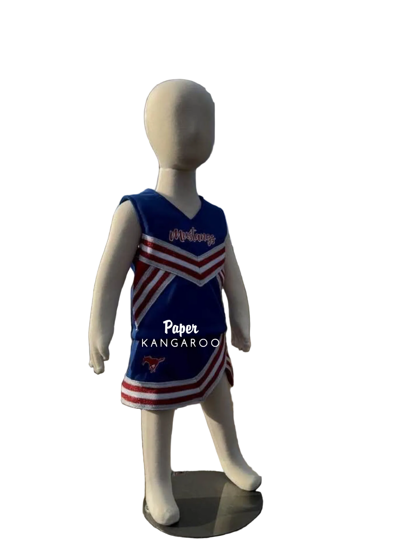 A children's cheerleader-style sleeveless dress displayed on a white mannequin outdoors. The dress is royal blue with red and white diagonal stripes and the word 'Mustangs' across the chest.
