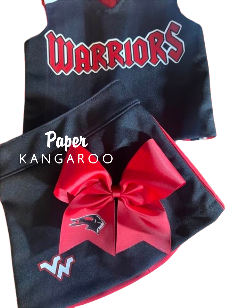 A black and red cheerleader outfit set featuring a sleeveless top with 'WARRIORS' in red and white, matching shorts with a large red bow and a bird logo, on a white background with a 'Paper Kangaroo' watermark.