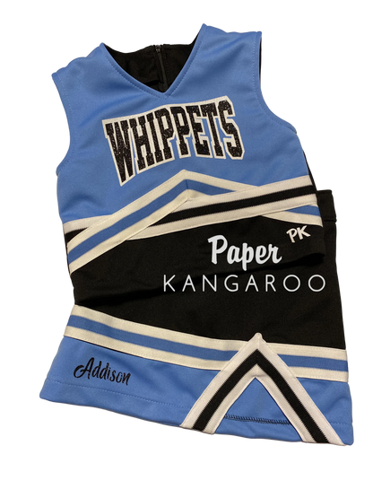 A custom cheerleader-style sleeveless jersey laid flat on a light beige surface. The jersey is light blue and black with white stripes and lettering.