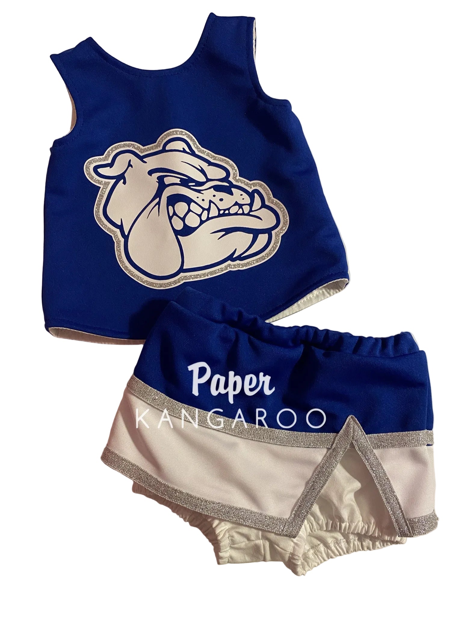 A two-piece toddler cheerleader outfit set consisting of a royal blue sleeveless top with a white bulldog mascot graphic, and matching blue and white shorts with silver glitter trim and 'Paper Kangaroo' text.