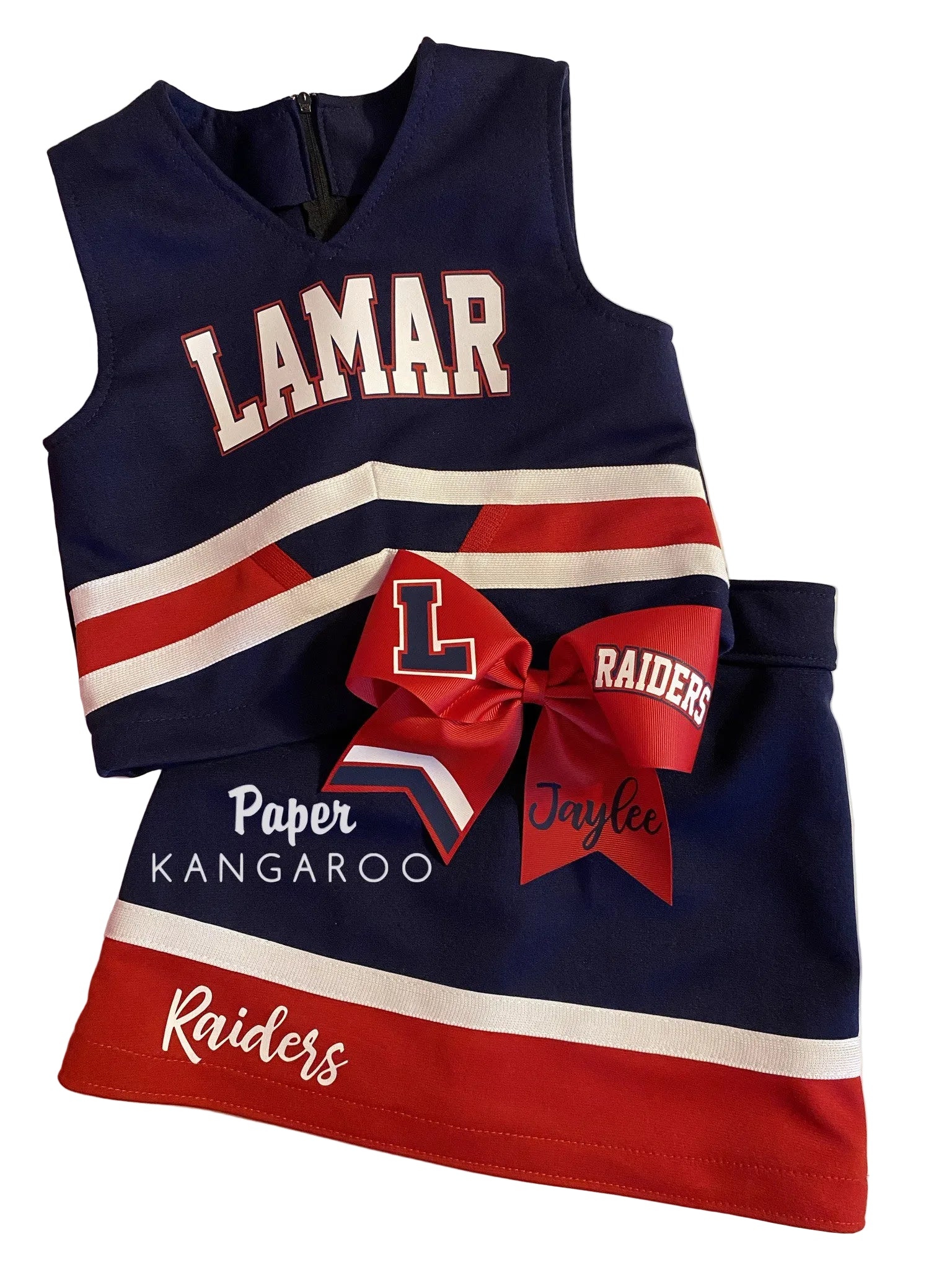 A navy blue, red, and white cheerleader outfit set featuring a sleeveless top with 'LAMAR' text, a matching skirt with 'Raiders' text, and a large red bow with 'L' and 'Raiders' details.