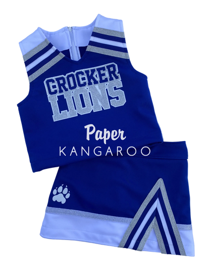 A custom cheerleader outfit set consisting of a sleeveless top and matching shorts in royal blue, white, and silver. The top features 'CROCKER LIONS' printed on the front, and the shorts display a white paw print logo.