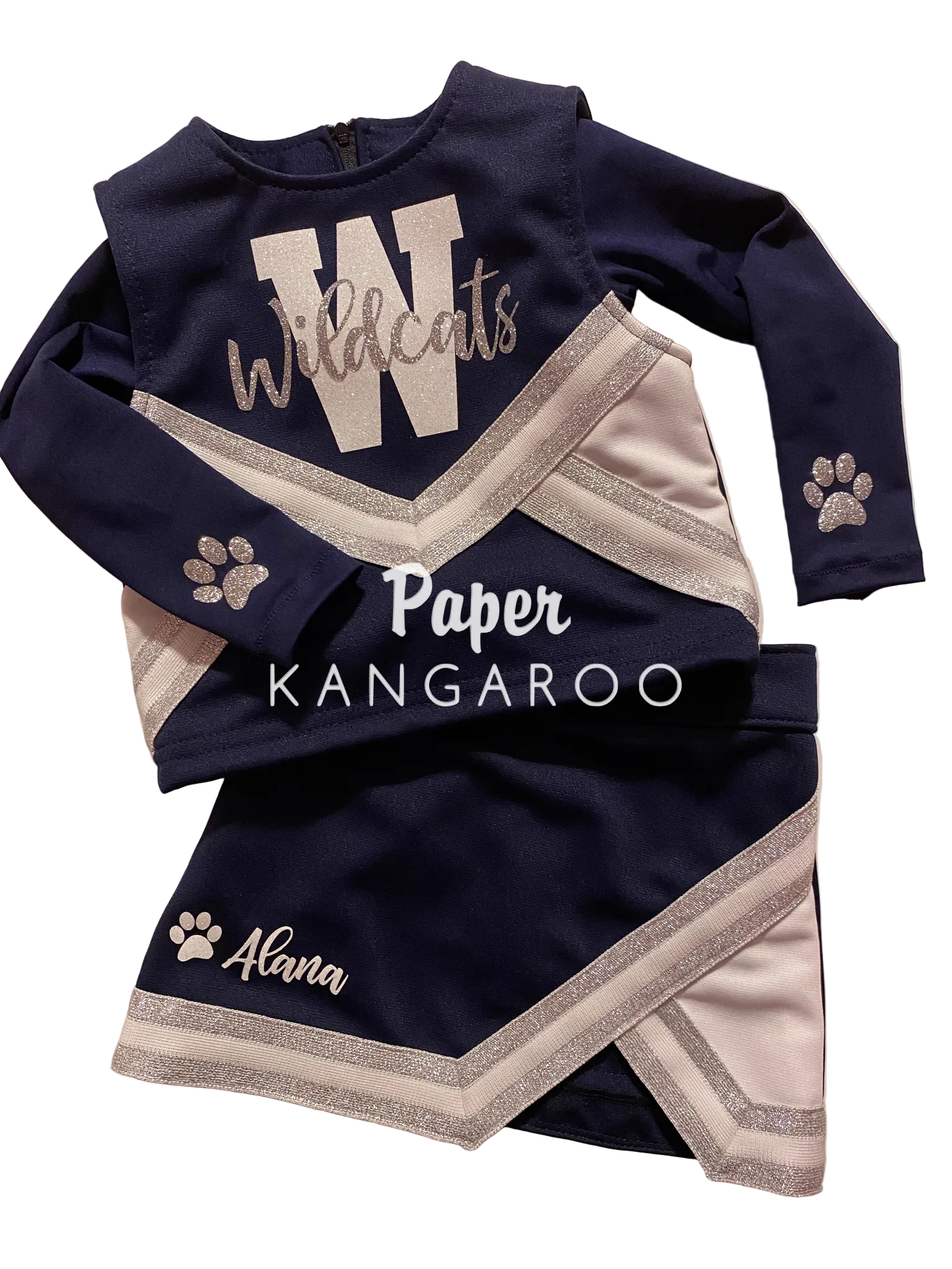 a navy blue childrens cheer outfit with silver and white trim a W and Wildcats across the chest and Alana on the skirt. Long sleeve crop top with silver paw prints at the wrist
