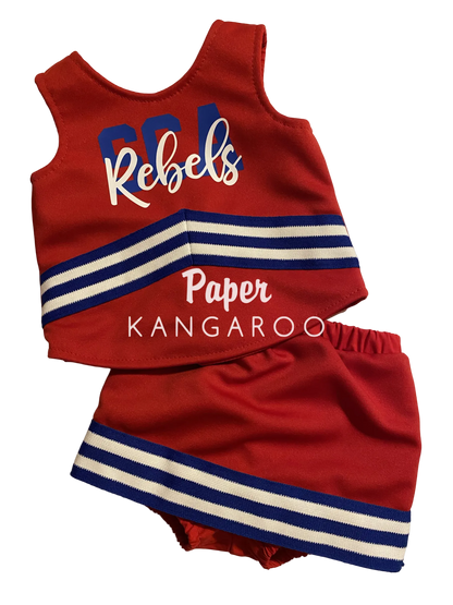 A red baby/toddler cheerleader outfit set consisting of a sleeveless top and matching shorts, featuring blue and white stripes and the words 'CFL Rebels' and 'Paper KANGAROO' printed on the front, laid flat on a light beige background.