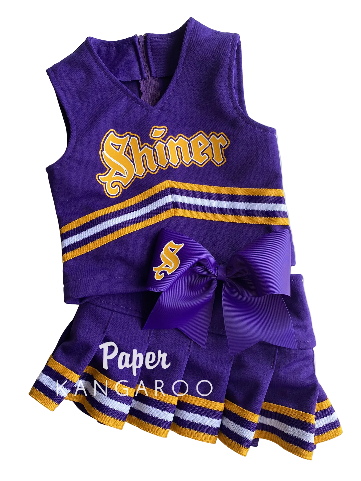 A purple girls' cheerleader costume set with a sleeveless top and matching pleated skirt, featuring gold and white stripes, a large purple bow, and 'Shiner' lettering on the front, photographed on a white background.