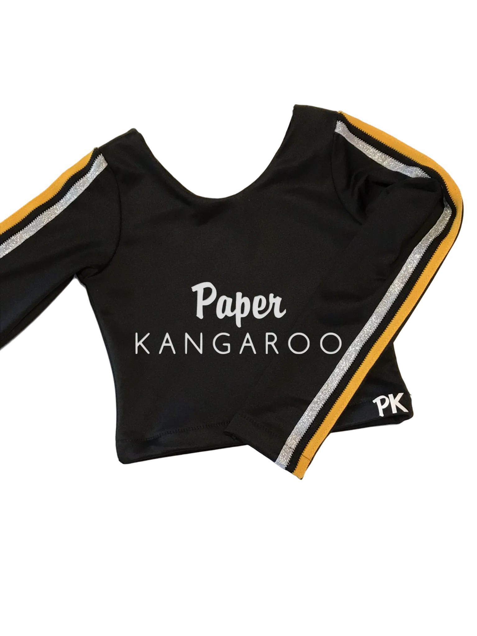 A black long-sleeve crop top with white 'Paper KANGAROO' text on the front, featuring gold and silver glitter stripes along the sleeves and a small 'PK' logo on the cuff, laid flat on a light beige background.