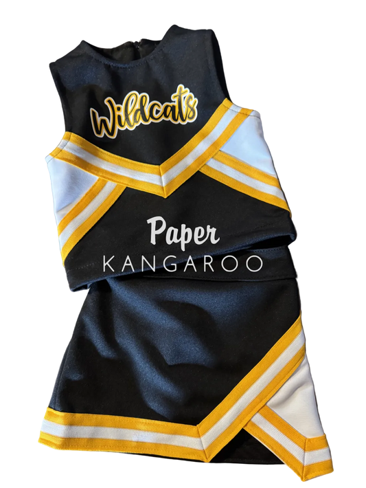 A custom children's cheerleader outfit consisting of a black top and matching skirt with yellow and white chevron stripes. The top features the word 'Wildcats' in yellow script with a white outline, and the center is printed with 'Paper KANGAROO' in white text.