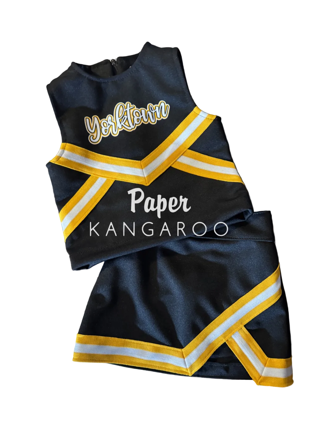 A custom cheerleader outfit set consisting of a black top and matching shorts with yellow and white striped trim, laid flat on a wooden table. The top features 'Yorktown' in white script with a gold outline, and the bottom features 'Paper KANGAROO' in white text.